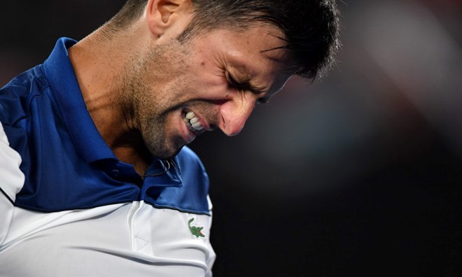 Djokovic lại phải sớm chia tay Australian Open. (Nguồn: Guardian)