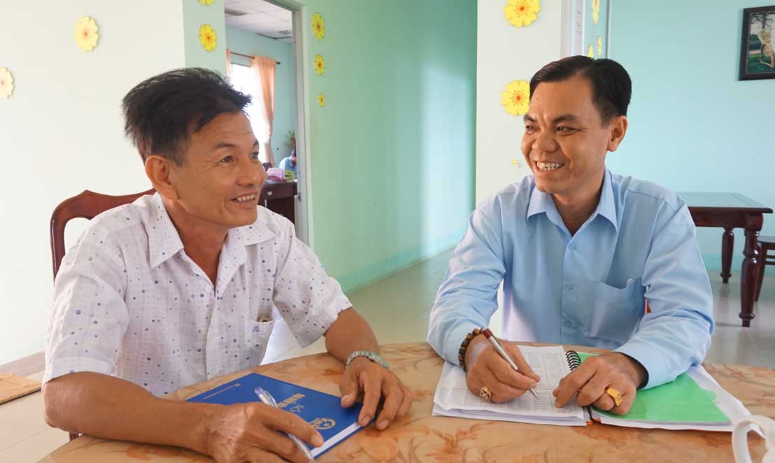 Ông Lê Văn Phương (bìa trái) và Bí thư Đảng ủy xã Bình Hòa Trung - Nguyễn Thanh Phong thảo luận công việc