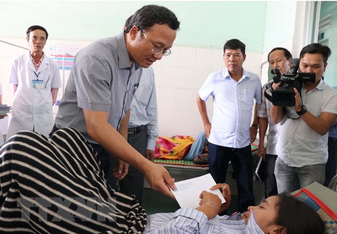 Phó Chủ tịch Ủy ban An toàn Giao thông Quốc gia Khuất Việt Hùng thăm hỏi các nạn nhân bị thương đang được điều trị tại bệnh viện. (Ảnh: Dư Toán/TTXVN)