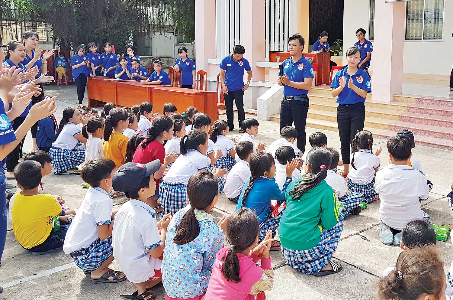 Phan Thị Hải Yến (đứng phía trên vỗ tay, bìa phải) tham gia tổ chức hoạt động hè cho trẻ trong chiến dịch Mùa hè xanh