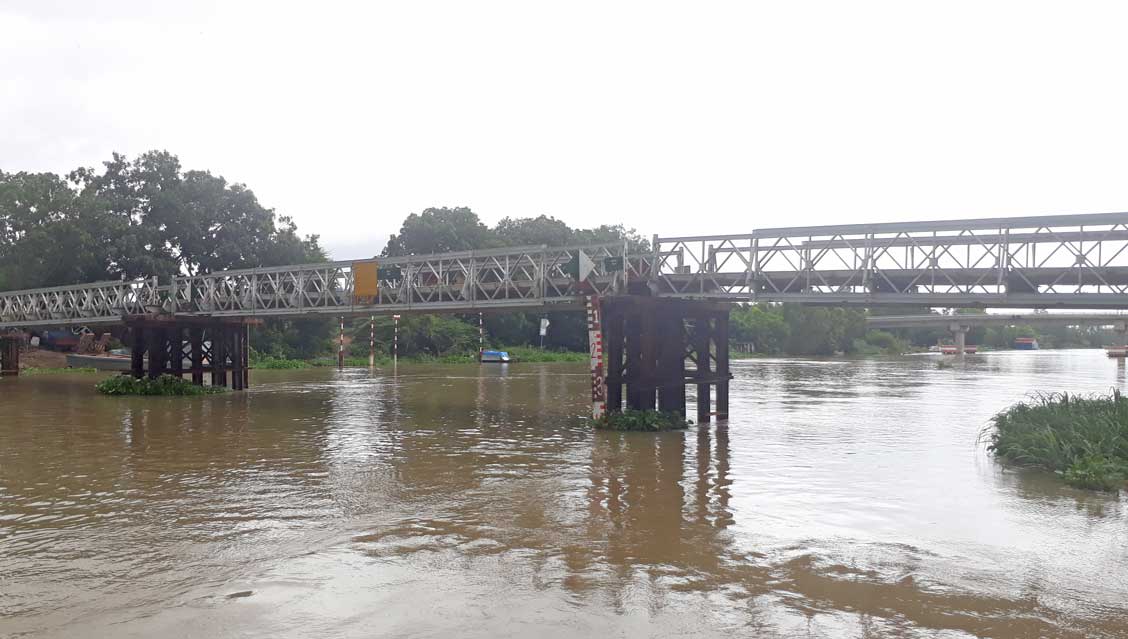 Nước lũ dâng cao, độ thông thuyền của cây cầu tạm ngày càng thấp gây khó khăn cho giao thông đường thủy