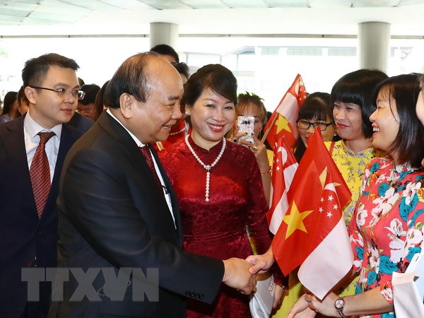 Cán bộ, nhân viên Đại sứ quán Việt Nam đón Thủ tướng Nguyễn Xuân Phúc và Phu nhân tại sân bay quốc tế Changi. (Ảnh: Thống Nhất/TTXVN)