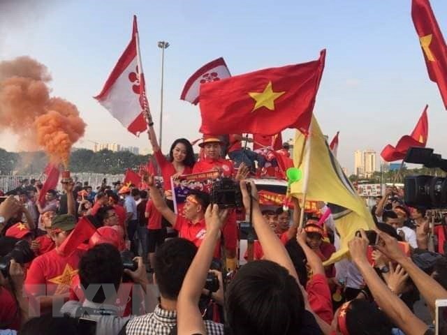 Cổ động viên cổ vũ đội tuyển Việt Nam bên ngoài sân vận động Mỹ Đình. (Ảnh: Thành Đạt/TTXVN)