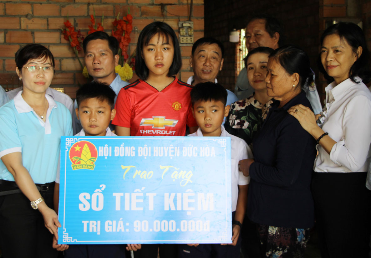 Hội đồng Đội huyện Đức Hòa tặng biểu trưng sổ tiết kiệm cho 3 em nhỏ có cha mẹ bị điện giật tử vong