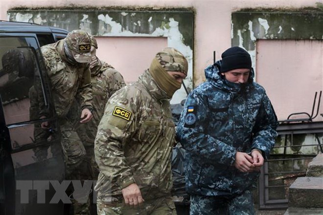 Nhân viên mật vụ thuộc Cơ quan An ninh Liên bang Nga áp giải một thủy thủ Ukraine (phải) bị bắt tới tòa án ở Simferopol, Bán đảo Crimea ngày 27/11/2018. (Nguồn: AFP/TTXVN)