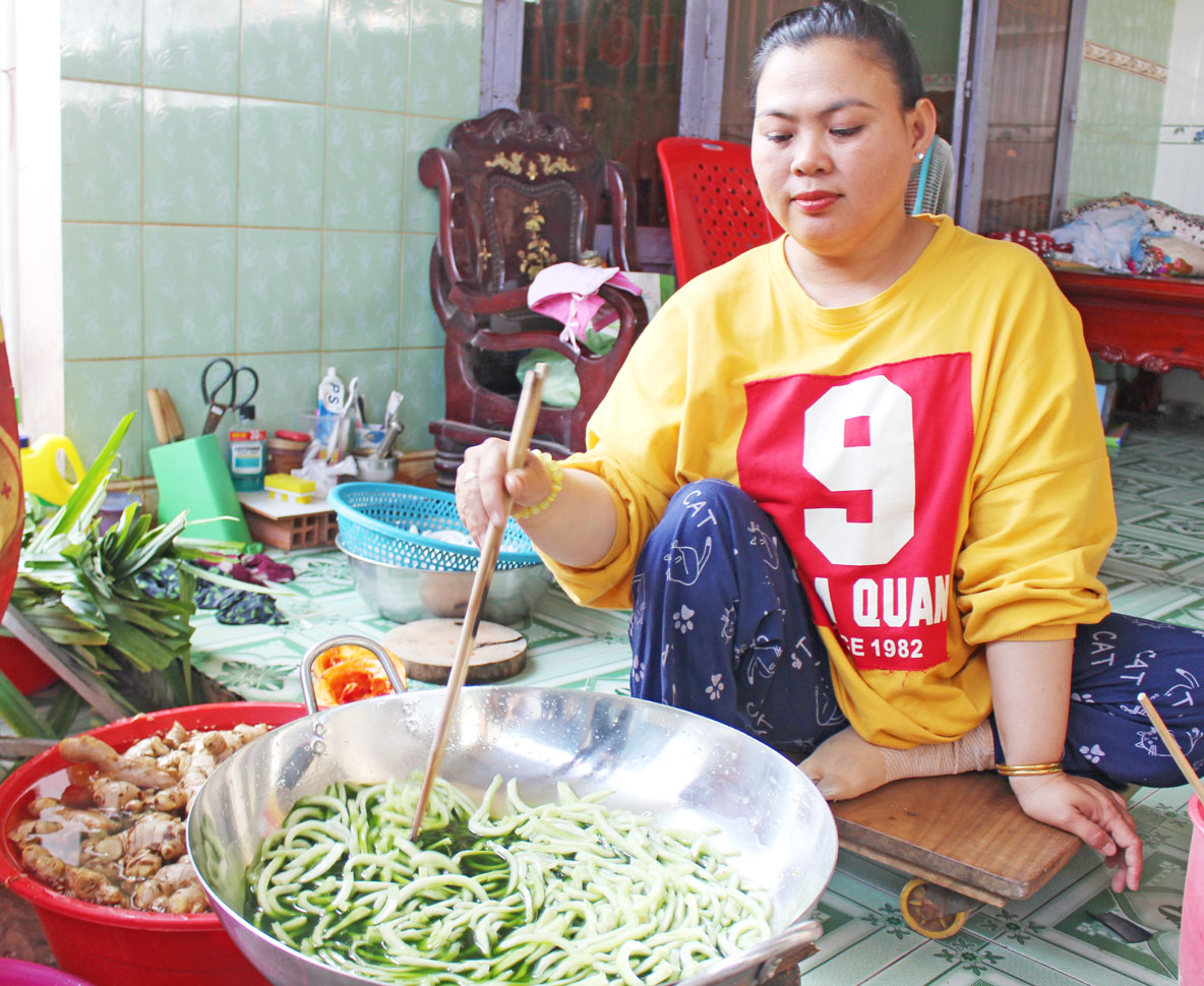 Sau khi bán vé số về, chị Ánh Hồng tranh thủ thời gian làm mứt dừa bán kiếm thêm thu nhập