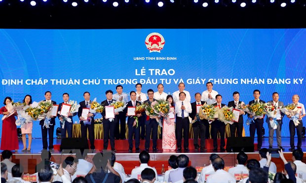 Thủ tướng Nguyễn Xuân Phúc chứng kiến Lễ trao Quyết định chấp thuận chủ trương đầu tư và Giấy chứng nhận đầu tư cho các doanh nghiệp. (Ảnh: Thống Nhất/TTXVN)