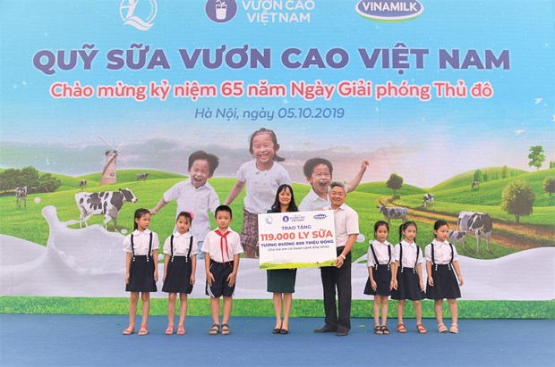  Bà Nguyễn Minh Tâm – Giám đốc Chi nhánh Vinamilk Hà Nội trao tặng bảng tượng trưng 119.000 ly sữa của Quỹ sữa Vươn cao Việt Nam cho hơn 1,300 em học sinh có hoàn cảnh khó khăn tại Hà Nội. (Ảnh: CTV)