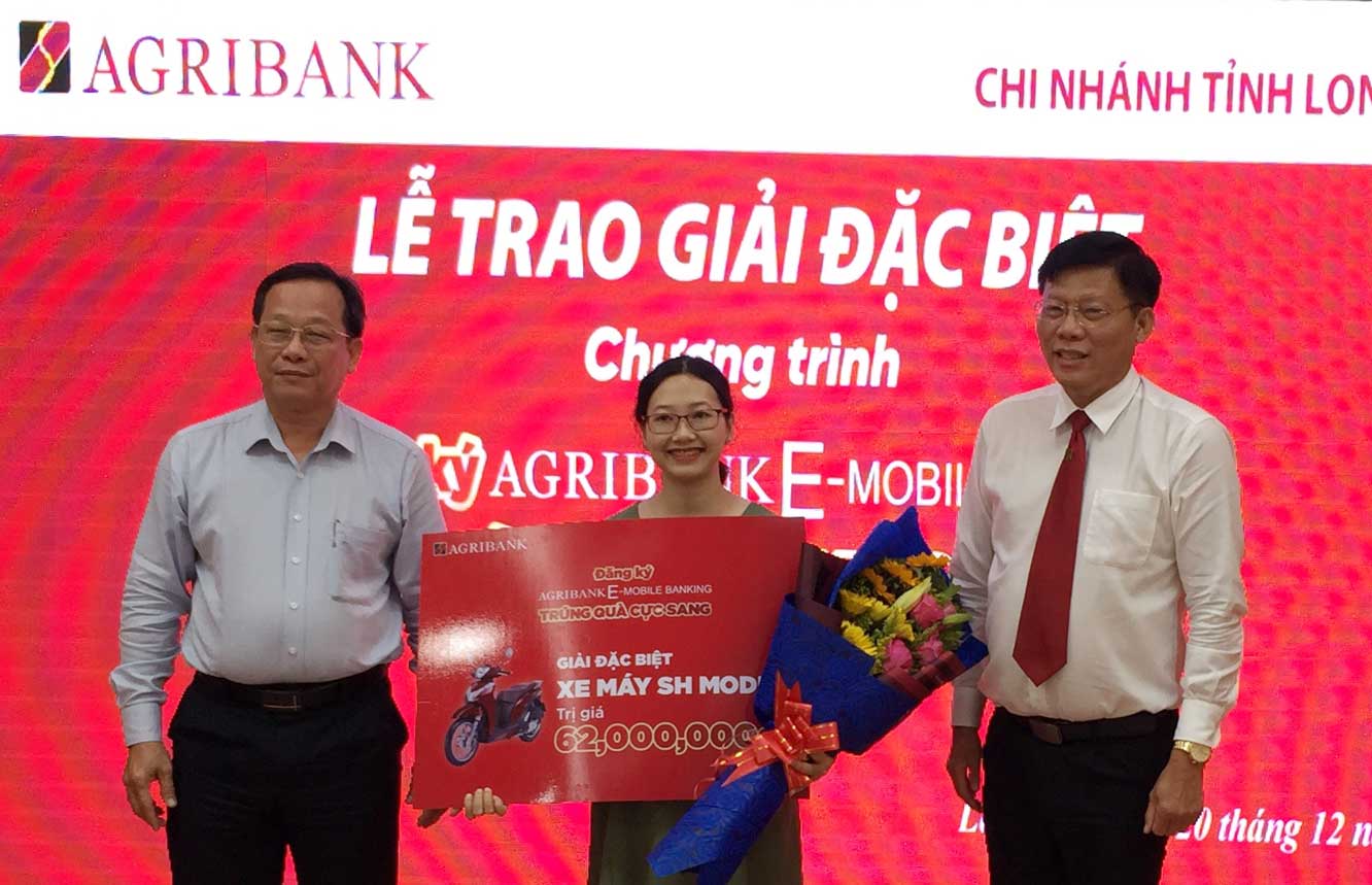 Giám đốc Ngân hàng Nhà nước Việt Nam Chi nhánh tỉnh Long An - Đào Văn Nghiệp (bìa trái) và Giám đốc Agribank LA – Nguyễn Kim Thài (bìa phải) trao giải giải đặc biệt của chương trình cho khách hàng Cao Thanh Hoa tại TP. Tân An