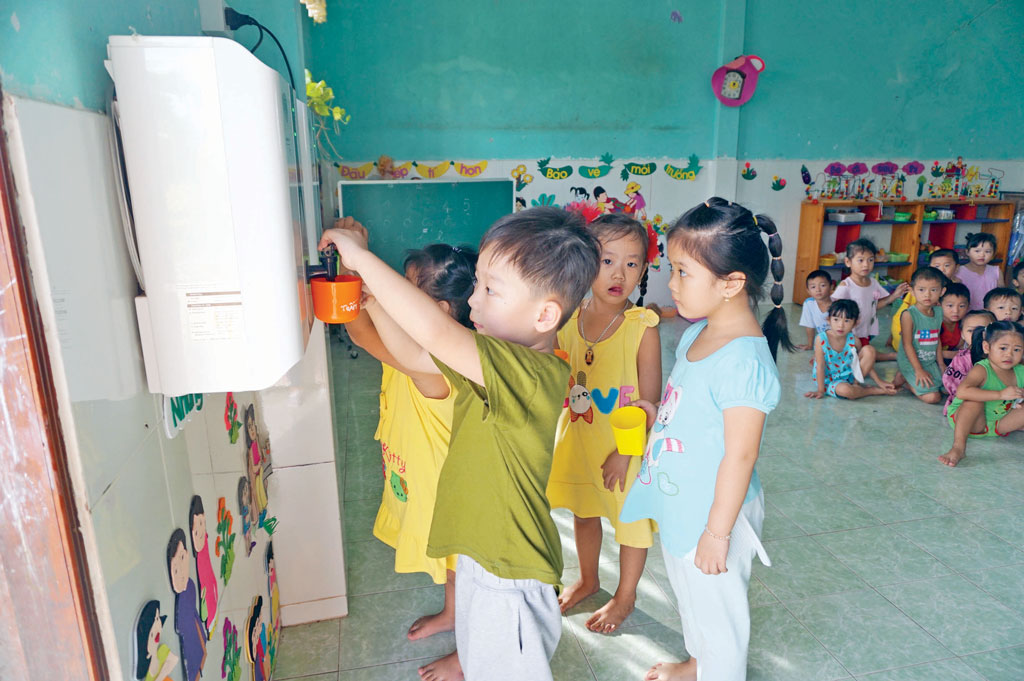 Các bé Trường Mẫu giáo Nhựt Ninh uống nước trực tiếp từ hệ thống lọc nước do bác Tư vận động tài trợ