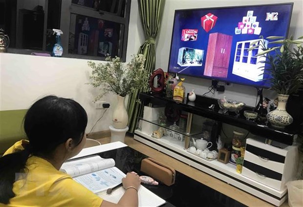 Học sinh trường Tiểu học Phương Mai (Đống Đa, Hà Nội) học qua truyền hình tại nhà. (Ảnh: TTXVN phát)