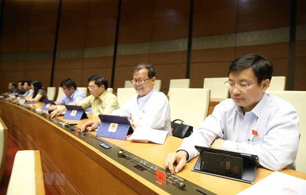 Legislators to vote on four laws on June 17 At a NA working session (Photo: VNA)