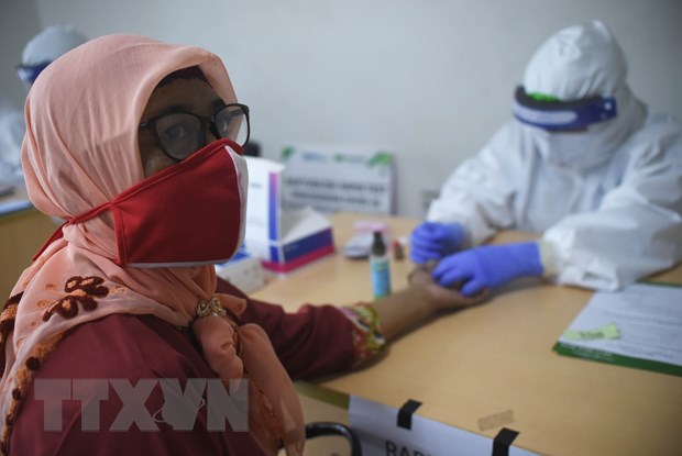 Nhân viên y tế lấy mẫu xét nghiệm COVID-19 tại Jakarta, Indonesia, ngày 15/7. (Ảnh: AFP/TTXVN)
