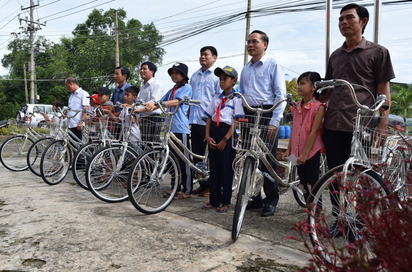 Bicycles are presented to needy students performing well in school