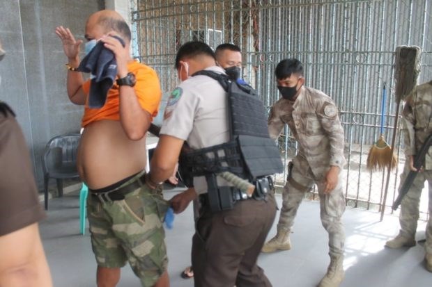 Jail guards inspect prisoners. (Photo from BuCor)