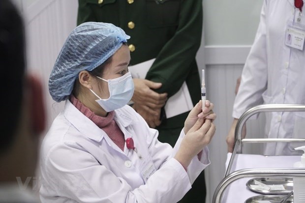 Top 10 outstanding events in Vietnam in 2020 A medical worker prepares to inject Nanocovax, Vietnam's first vaccine against COVID-19, into a volunteer as part of the human trials (Photo: VNA)