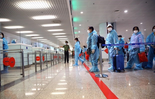 People wait in line to complete customs procedures before entering Vietnam (Photo: VNA)