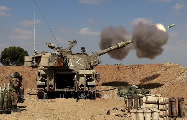 Vietnam condemns attacks on civilians in Israel-Palestine conflict Israeli troops fire towards the Gaza Strip from their post in Sderot city of Israel (Photo: AFP/VNA)