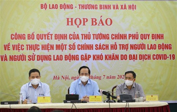 Minister of Labour, Invalids and Social Affairs Dao Ngoc Dung (C) at the press conference (Photo: VNA)