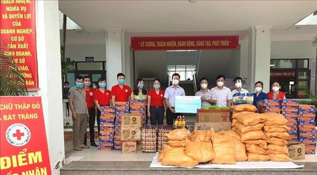 Red Cross launches campaign to support COVID-19-hit residents  The Gia Lam District Red Cross Society present gifts to disadvantaged people and the frontline force of Bat Trang commune. (Photo: VNA)