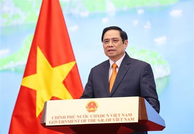 Prime Minister Pham Minh Chinh attends and delivers a speech at the 2021 Global Trade in Sevices Summit via video (Photo: VNA)
