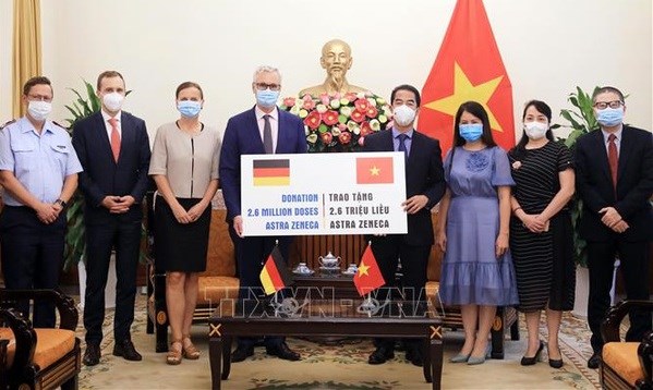Overseas Vietnamese, int’l friends make great contributions to Vietnam’s vaccine coverage goal Deputy Minister of Foreign Affairs To Anh Dung (fourth, right) symbolically receives 2.6 million AstraZeneca COVID-19 vaccine from German Abassador to Vietnam Guido Hildner. (Photo: VNA)