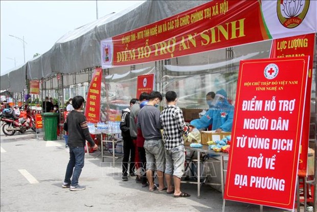Vietnam spends nearly 2 billion USD on COVID-19 fight Workers returning from southern provinces receive free food and drink while passing through Nghe An province on October 9. (Photo: VNA)