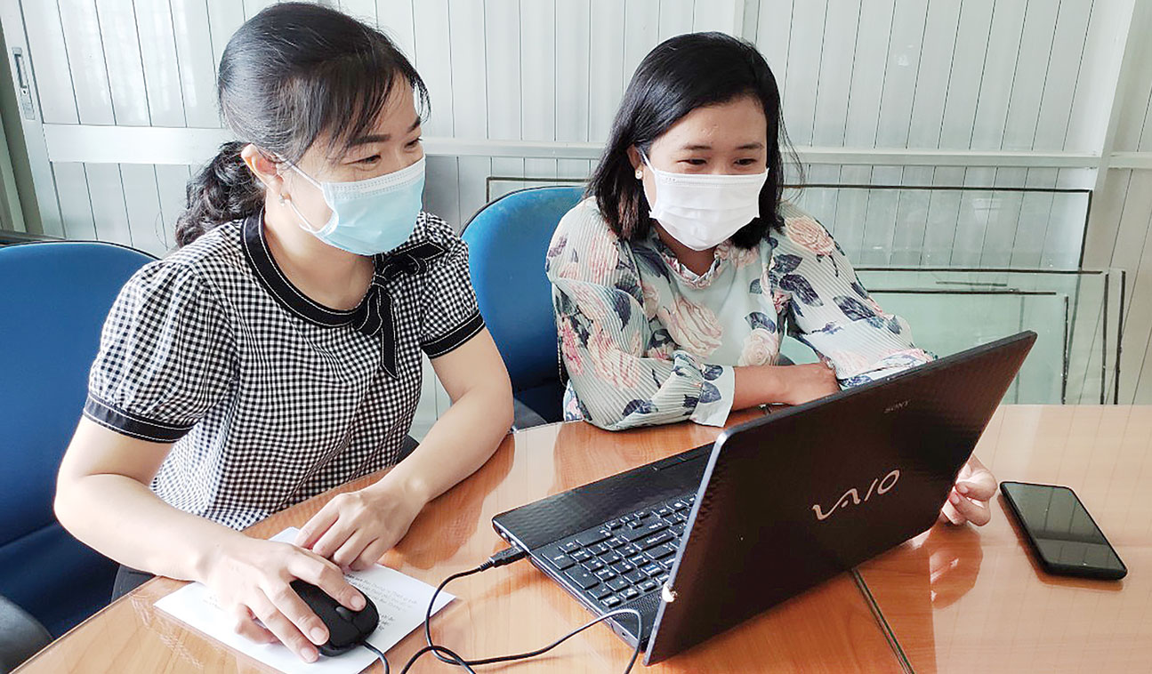 Cô Bùi Thị Kim Huệ (bên trái) và cô Võ Hoàng Quế Anh (bên phải) chuẩn bị  bài học để hướng dẫn trẻ ôn tập, tự học tại nhà