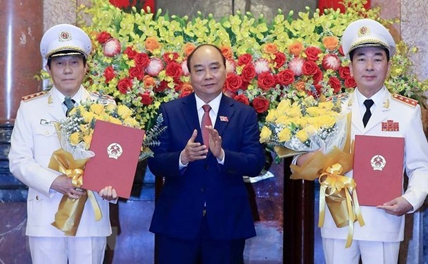 Two deputy ministers of public security promoted to Senior Lieutenant General President Nguyen Xuan Phuc (middle) presents the promotion decisions to two deputy ministers of public security (Photo: VNA)