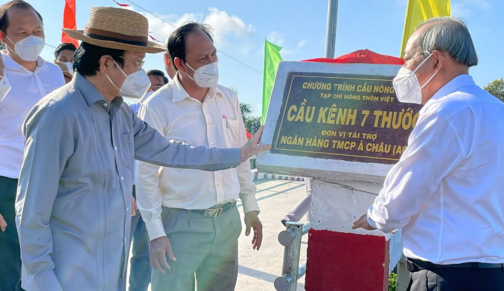 Former State President - Truong Tan Sang (L) attend the inauguration of the rural traffic bridge
